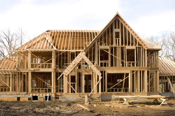 McMansion type house under construction in framing phase — Stock Photo, Image