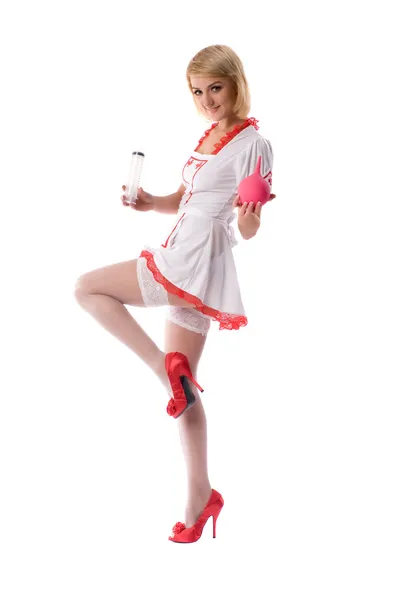 Sexy jonge verpleegster met klysma en een injectiespuit in zijn hand — Stockfoto