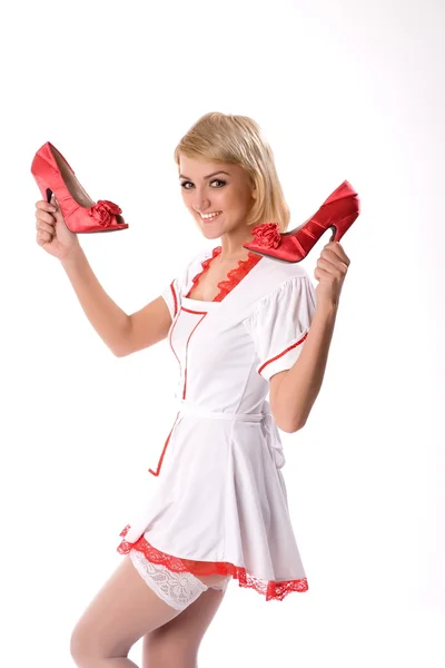 Sexy mladá dívka drží červený boty — Stock fotografie