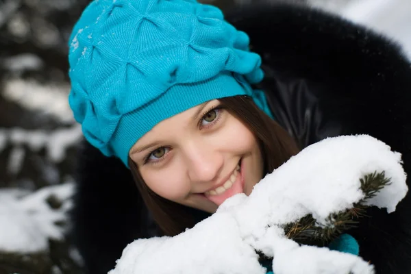 Cheerful young girl tries to taste the white snow — Stock Photo, Image
