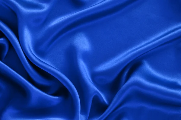 Niebieskim tle satyna — Zdjęcie stockowe