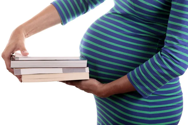 Femme enceinte tenant une pile de livres Image En Vente