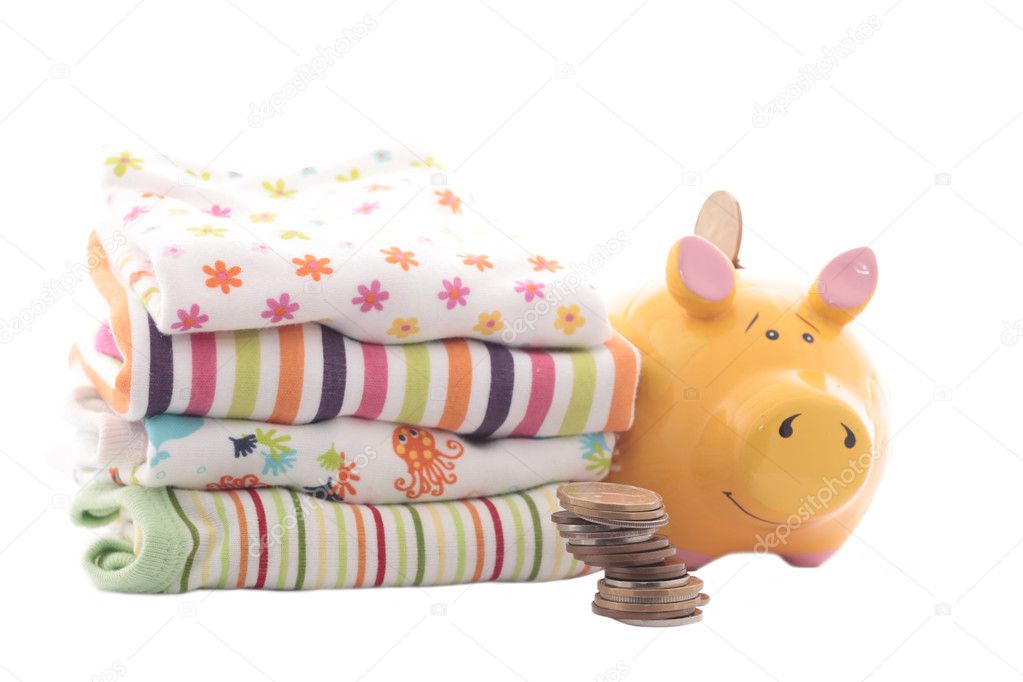 Yellow piggy bank with baby's clothes