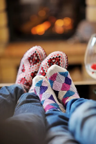 Young romantic couple relax on sofa in front of fireplace at hom — Stock Photo, Image