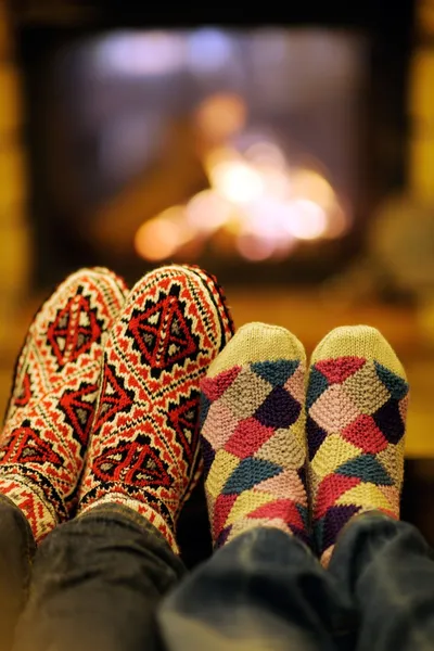 Young romantic couple relax on sofa in front of fireplace at hom — Stock Photo, Image