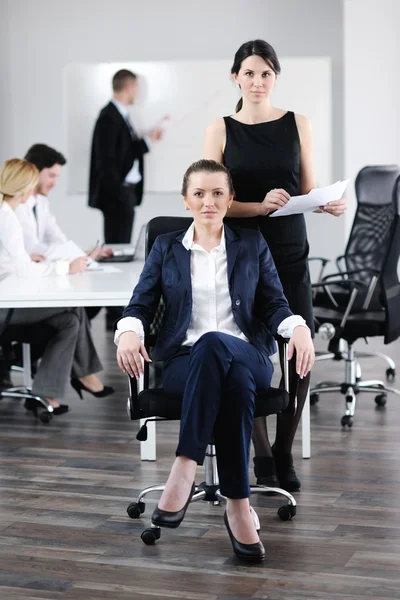 Mujer de negocios con su personal en segundo plano —  Fotos de Stock