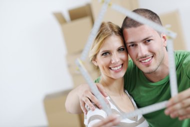 Young couple moving in new house clipart