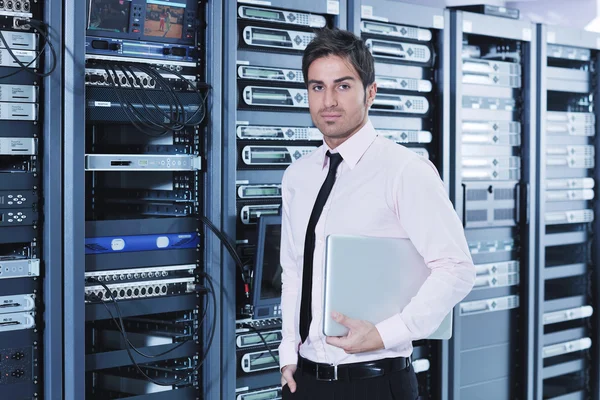 Businessman with laptop in network server room Royalty Free Stock Images