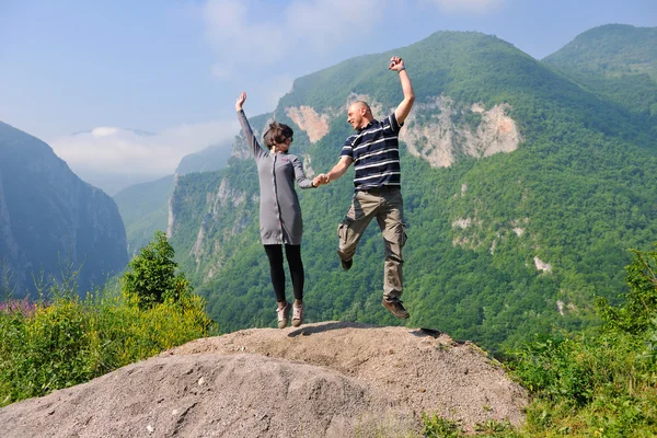 Happy young couple jumping in the air — Stock Photo, Image