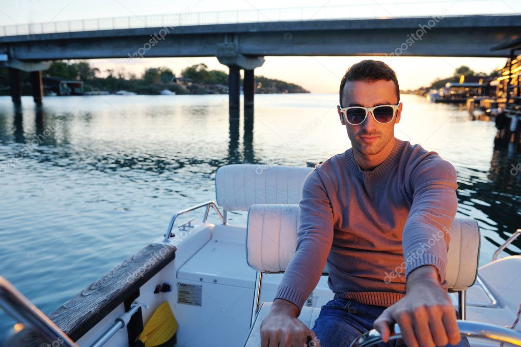 Portrait of happy young man on boat