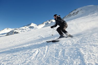 Güzel güneşli bir günde kış mevsiminde taze kar üzerinde kayak yapmak