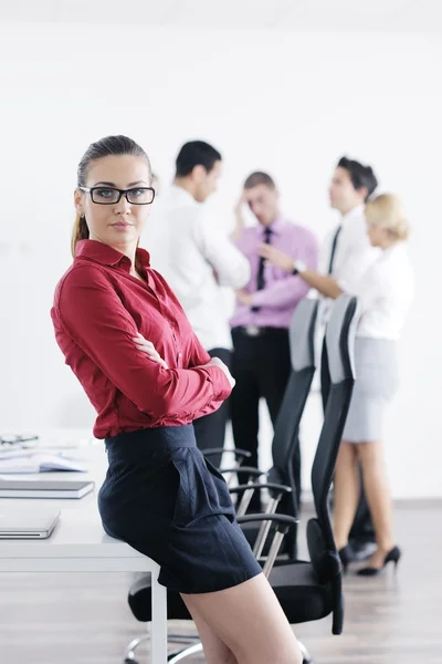 stock image Business woman standing with her staff in background