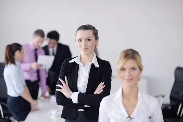 Obchodní žena stojící s její zaměstnanci v pozadí — Stock fotografie