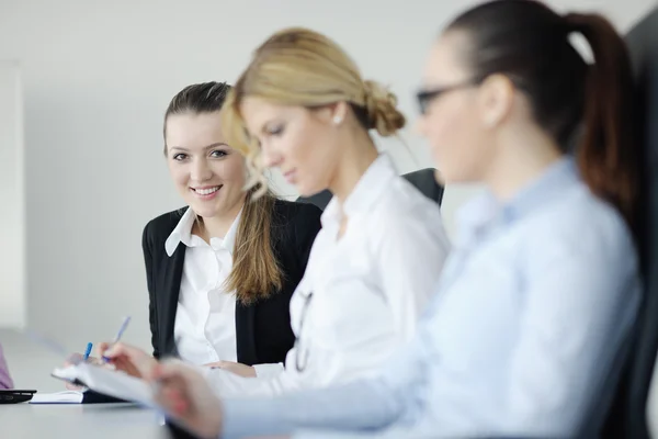 Business woman standing with her staff in background Stock Image