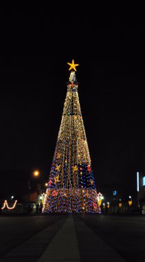 Huge Christmas tree in the city centre clipart