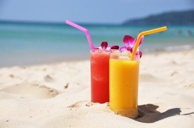 Pair of fruit shakes on the tropical beach clipart