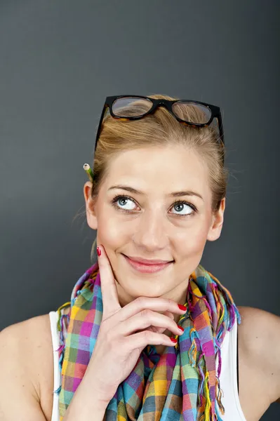 Jonge vrouw kijken omhoog op blauwe achtergrond — Stockfoto