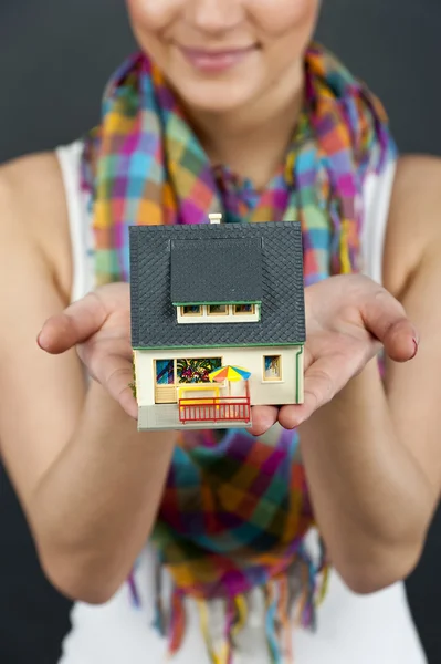 Siyah arka plan üzerine bir minyatür ev kadını — Stok fotoğraf