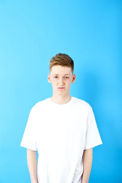 Young man on blue background — Stock Photo, Image