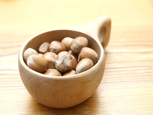 Tasty hazelnuts in wooden cup — Stock Photo, Image
