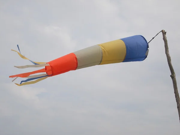 A windsock inflated by the wind on the sky — Stock Photo, Image