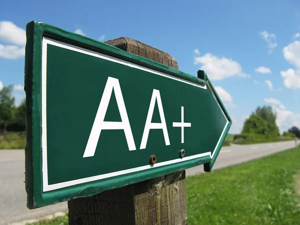 AA-plus (credit rating) signpost along a rural road — Stock Photo, Image