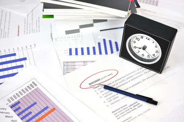 Pen and clock on the financial reports — Stock Photo, Image