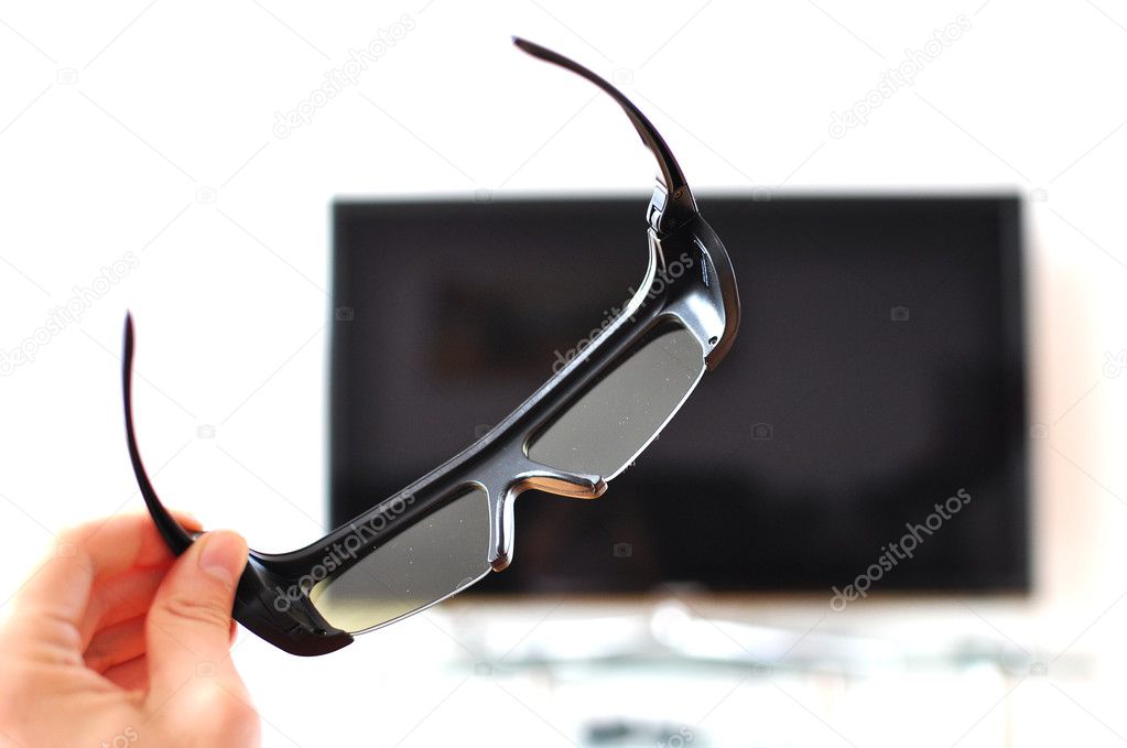 3d-glasses in the hand against TV-set