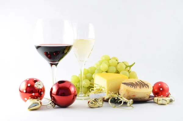 Pair of wineglasses, grapes, cheese and christmas tree toys — Stock Photo, Image