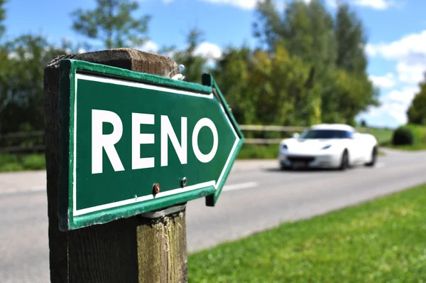 RENO sign against sportive car on the rural road — Stock Photo, Image