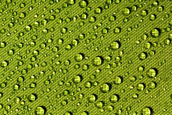 Gocce d'acqua su un tessuto impermeabile Fotografia Stock