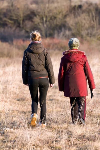 Grandmother and adult grandchild walking in outdoor — Stock Photo, Image
