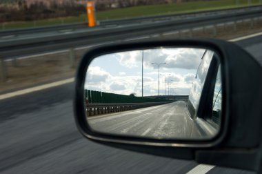 Landscape in the mirror of a car clipart