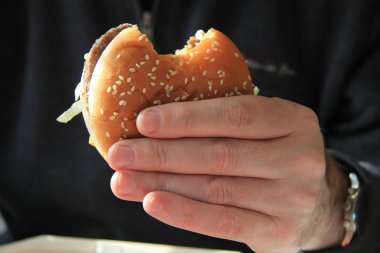 Man holding hamburger clipart