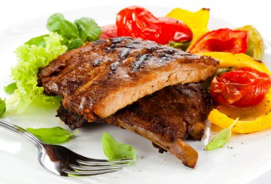 Tasty grilled ribs with vegetables clipart