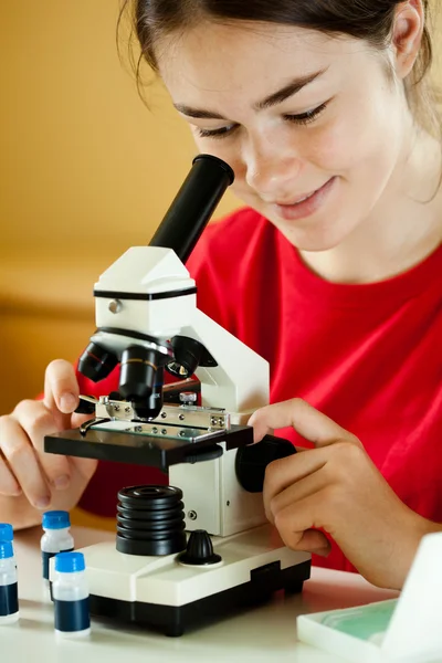 检查在显微镜下的制备的女孩 — 图库照片