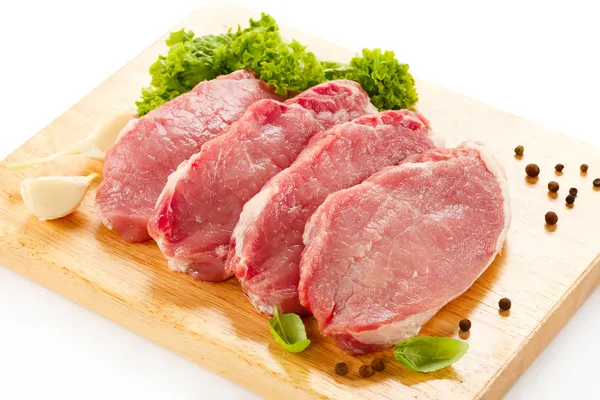 stock image Raw pork on cutting board and vegetables