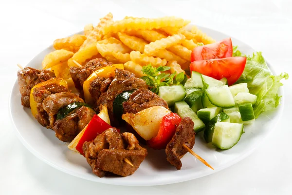 Grilled meat, French fries and vegetables — Stock Photo, Image