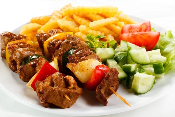 Grilled meat, French fries and vegetables — Stock Photo, Image
