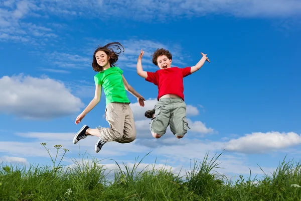 Girl and boy running, jumping outdoor — 스톡 사진
