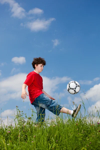 Jongen voetballen buiten — Stockfoto