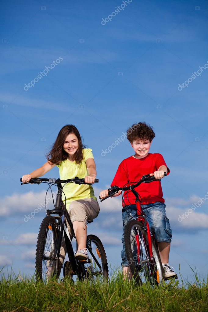 Girl and boy riding bikes — Stock Photo © gbh007 9701704