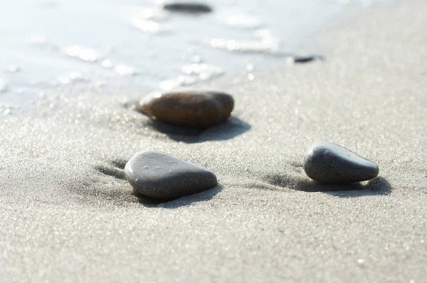 Pierres sur le sable à la mer, un caillou — Photo
