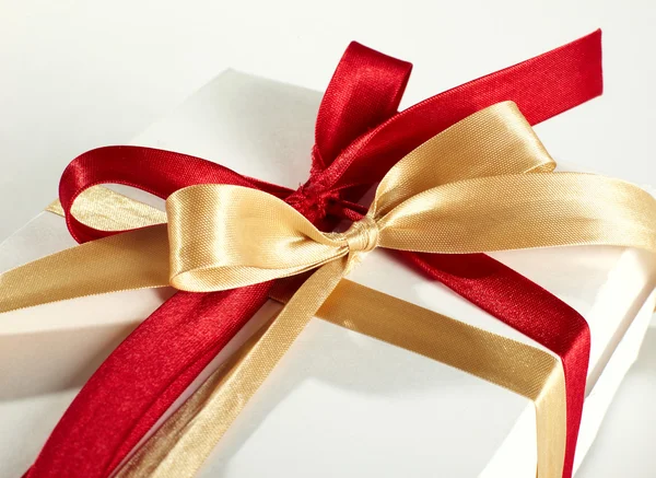 Big red, gold bow on white background — Stock Photo, Image