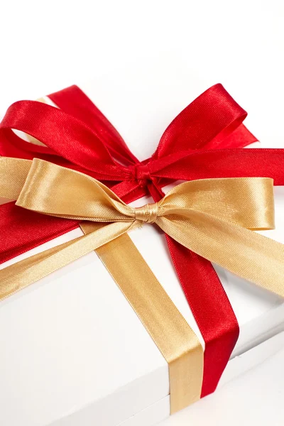 Big red, gold bow on white background Royalty Free Stock Images