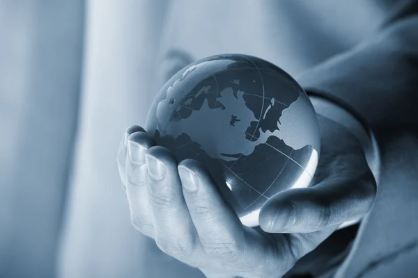 Businessman holding mini globe — Stock Photo, Image