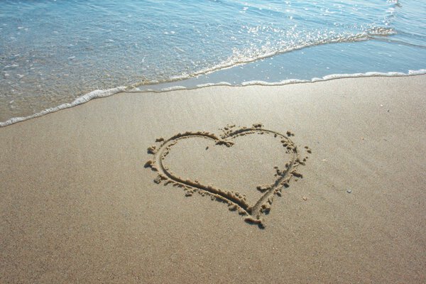 Heart drawn on sand, seacoast