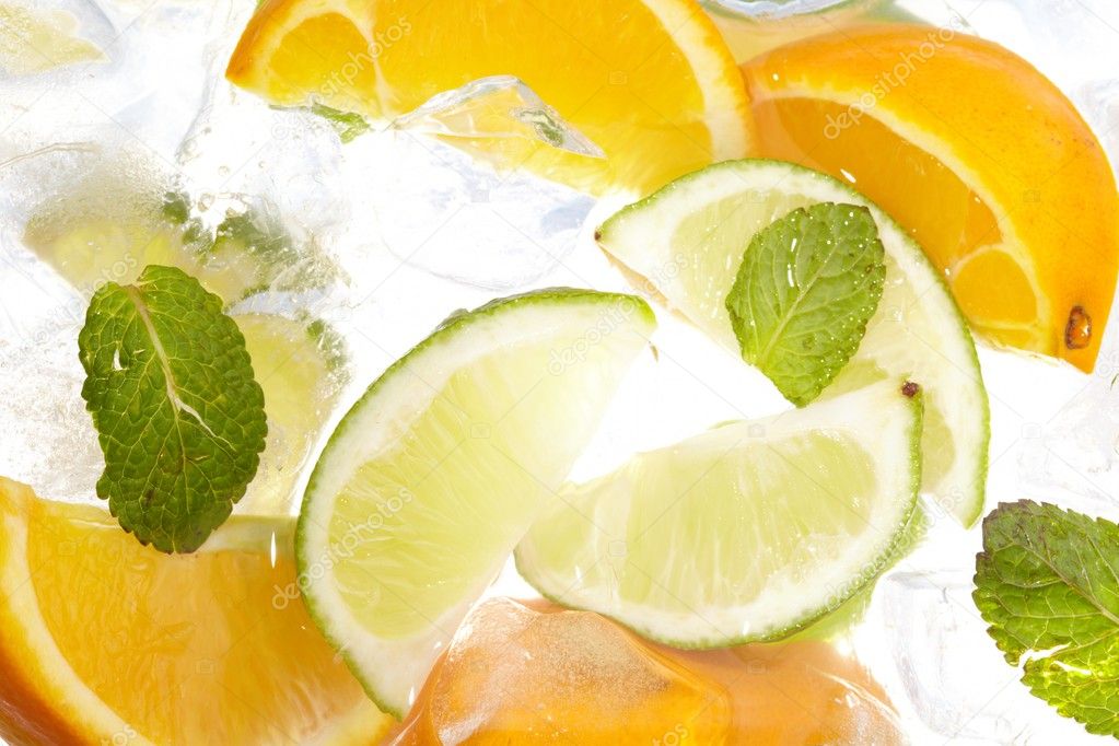 Leaf mint and cut citrus in ice