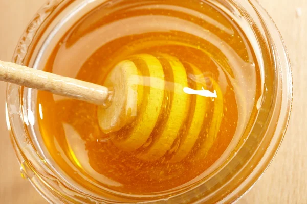 Honey with wood stick — Stock Photo, Image