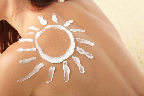 stock image Woman with sun-shaped sun cream